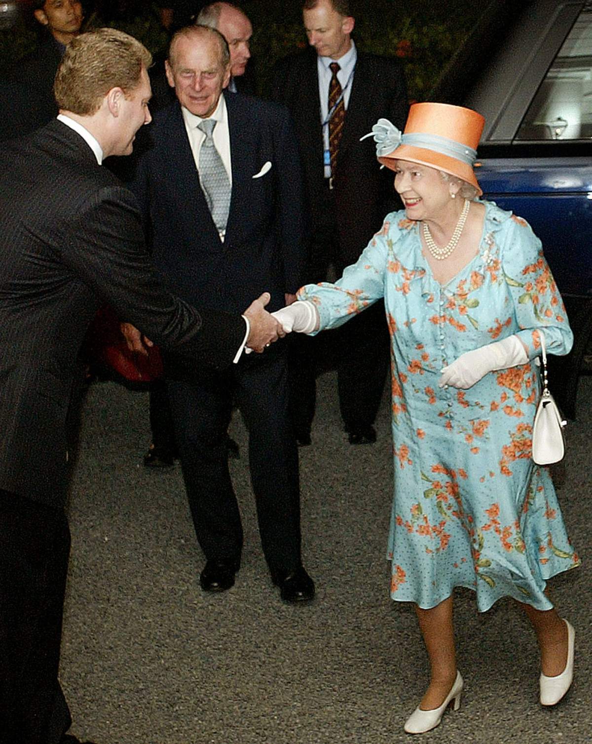 Queen Elizabeth II is greeted by Robert Logan, left, general manager of Raffles Hotel, where she stayed on a trip to Singpore in 2006.