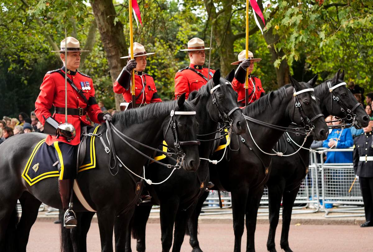 RCMP officers on horseback ride in the funeral procession as millions of people line the streets as the coffin of Queen Elizabeth leaves Westminster Abbey during her funeral in London on Monday, September 19, 2022. Queen Elizabeth, Britain's longest-reigning monarch and a rock of stability across much of a turbulent century, died Thursday Sept. 8, 2022, after 70 years on the throne.
