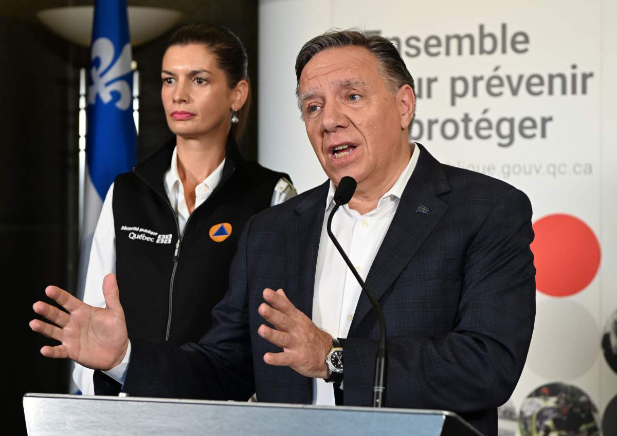 Coalition Avenir Québec Leader François Legault speaks at a news conference on the storm Fiona that hit the Gaspé and the Îles-de-la-Madeleine region overnight, Saturday, September 24, 2022 in Quebec City. Quebec Deputy premier and Public Security Minister Geneviève Guilbault, left, looks on. THE CANADIAN PRESS/Jacques Boissinot