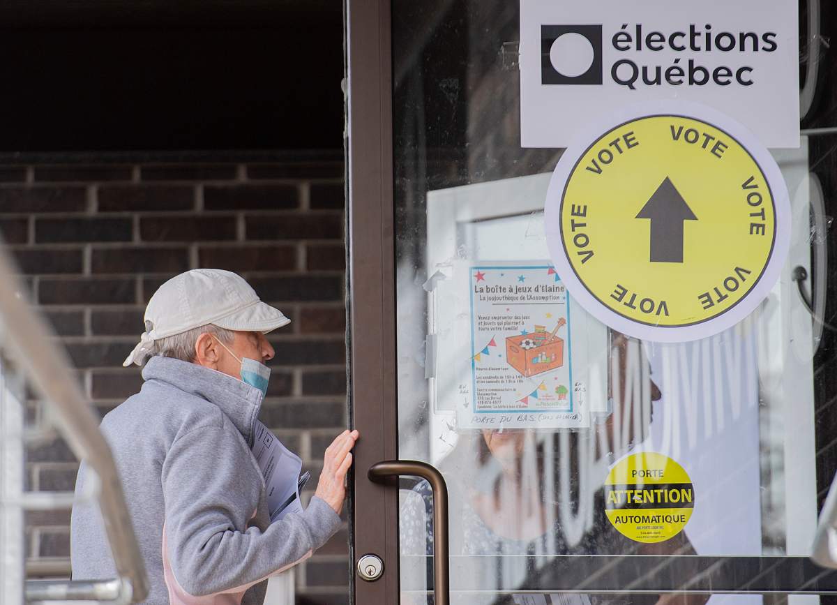 People enter a polling station in L’Assomption, Que., Sunday, September 25, 2022, as advanced polling begins ahead of the the Quebec election on October 3rd. THE CANADIAN PRESS/Graham Hughes