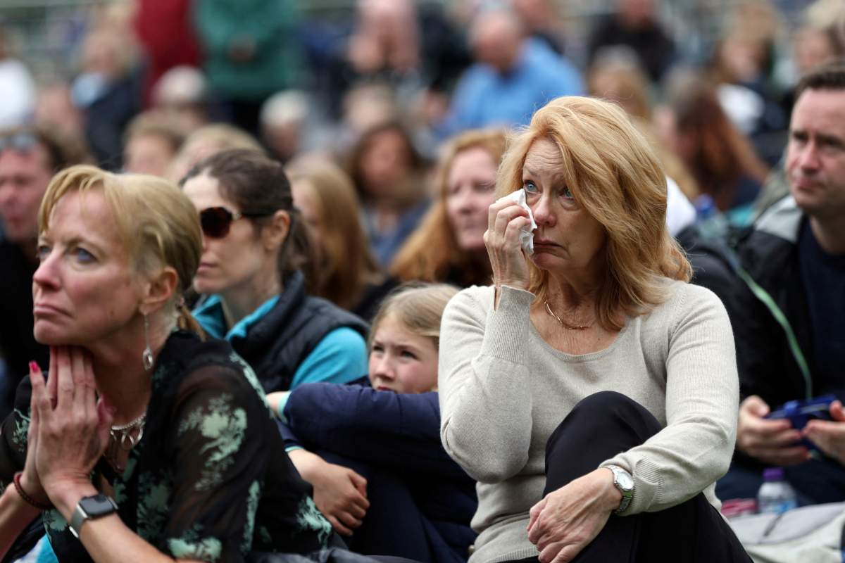 Mourners listen to the funeral of Britain’s Queen Elizabeth II, Monday, Sept. 19, 2022, in Windsor, England. (Lee Smith/Pool Photo via AP)