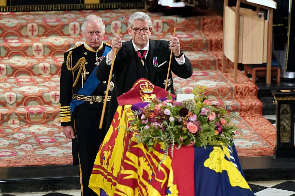 King Charles II, left, watches as The Lord Chamberlain Baron Parker breaks his Wand of Office, marking the end of his service to the sovereign, during a committal service for Britain’s Queen Elizabeth II at St George’s Chapel, Windsor Castle, in Windsor, England, Monday, Sept. 19, 2022. (Joe Giddens/Pool Photo via AP)