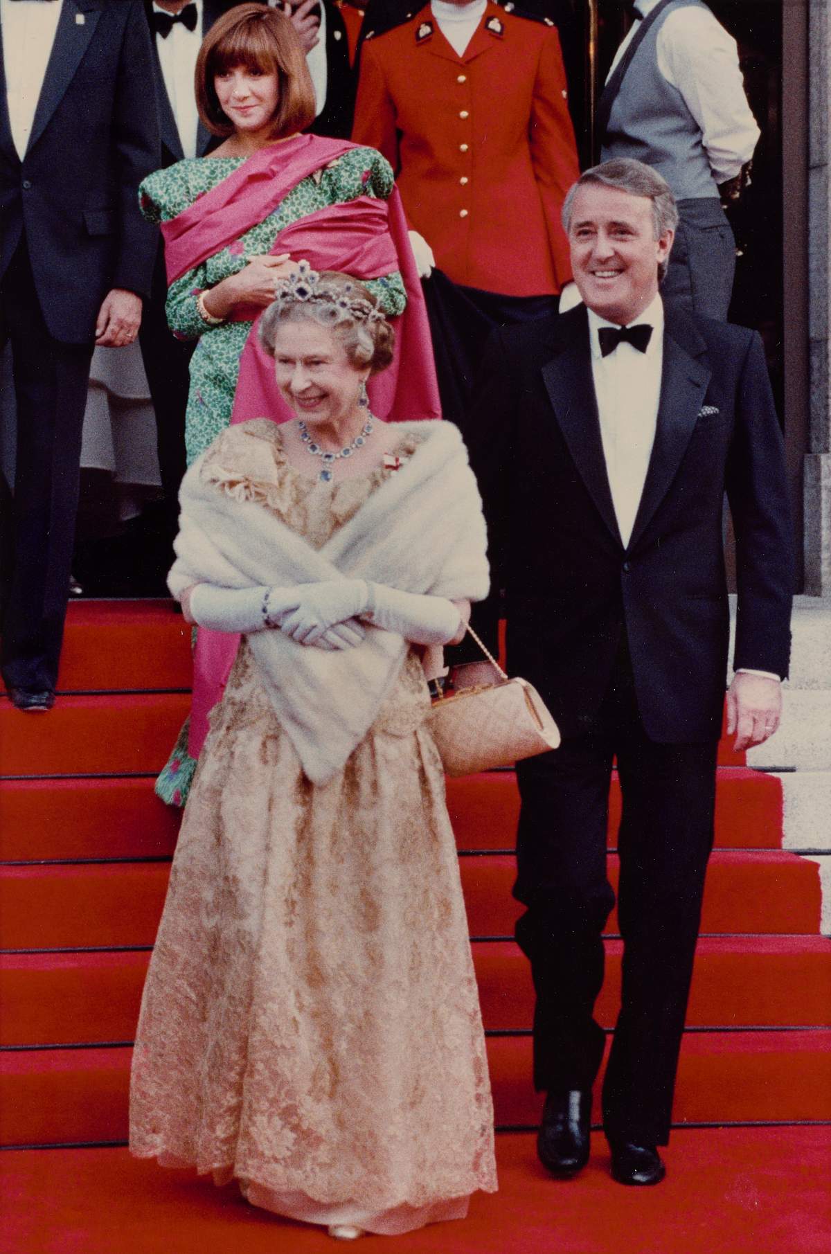 Queen Elizabeth II leaves the Calgary Concert Hall with Prime Minister Brian Mulroney and wife Mila after a performance by the Calgary Philharmonic Orchestra, in Calgary on June 28, 1990.