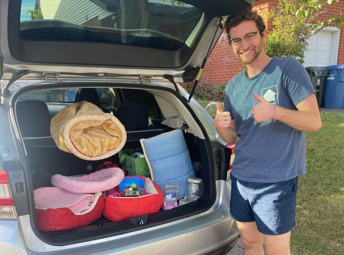Dylan Keith of FYFF with a trunkful of pet supplies.