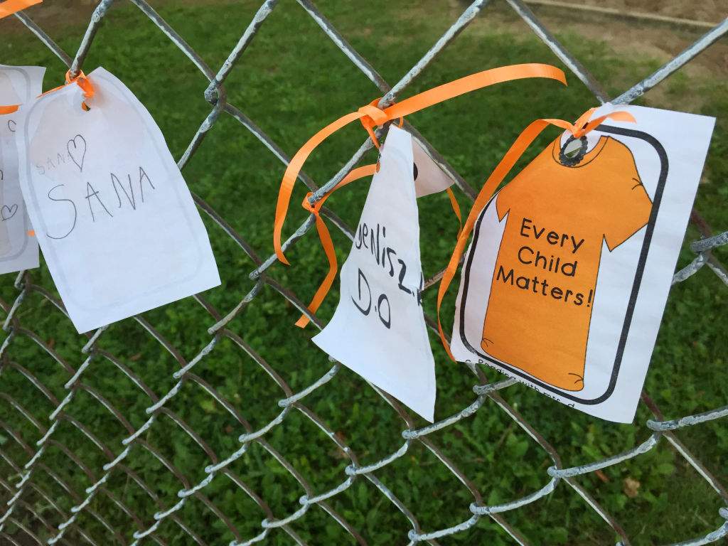 A note with the words 'every child matters' tied with orange ribbons