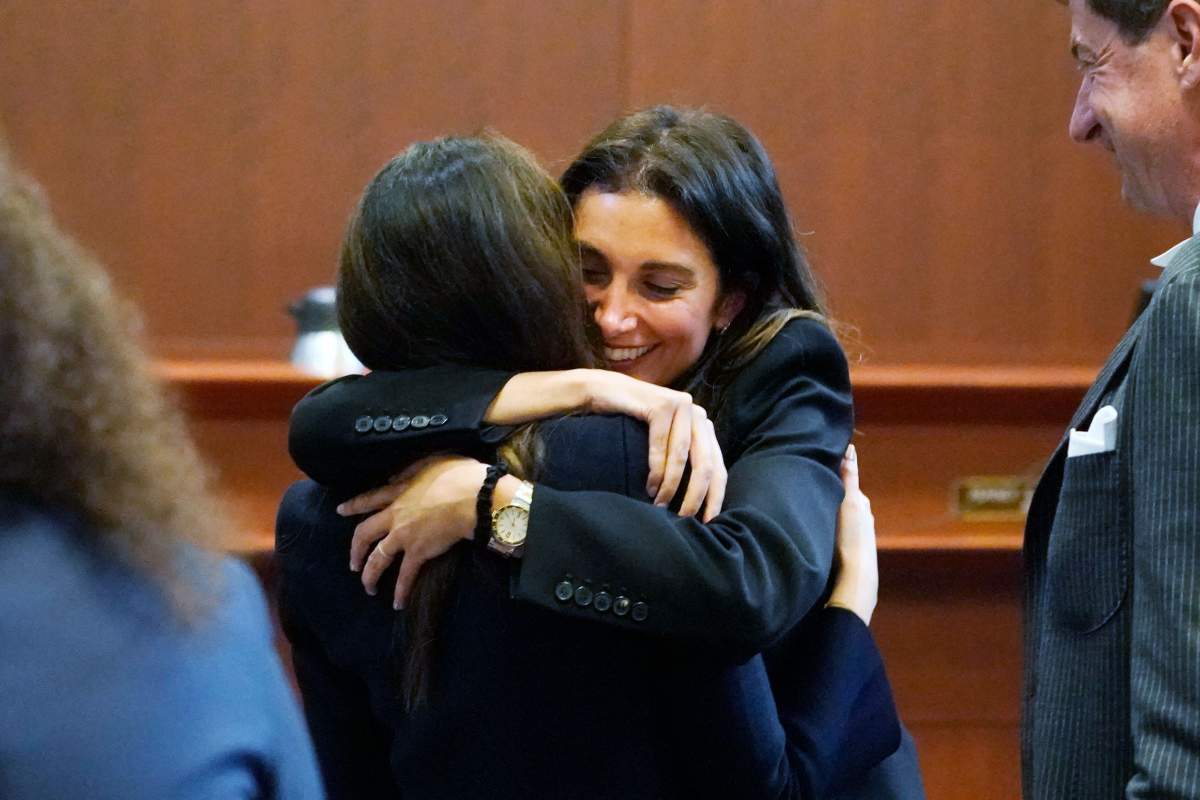 Camille Vasquez hugs Joelle Rich in a courtroom.