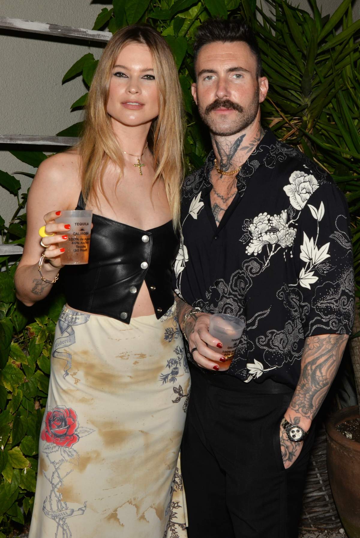 Behati Prinsloo and Adam Levine at the Calirosa Tequila Sunset Happy Hour at South Beach Wine & Food Festival on February 24th, 2022 in Miami Beach, Florida.