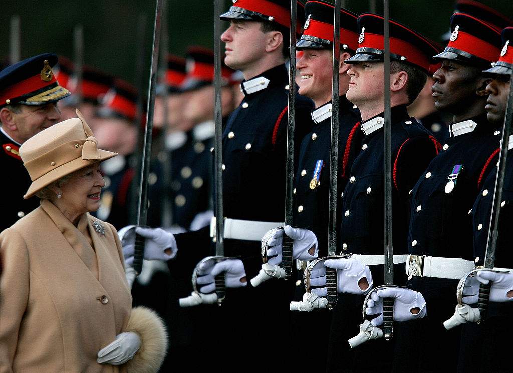 Britain's Queen Elizabeth II (L) smiles with her grandson Prince Harry (4th R) during the Sovereign's Parade at the Royal Military Academy in Sandhurst, southern England, April 12, 2006.