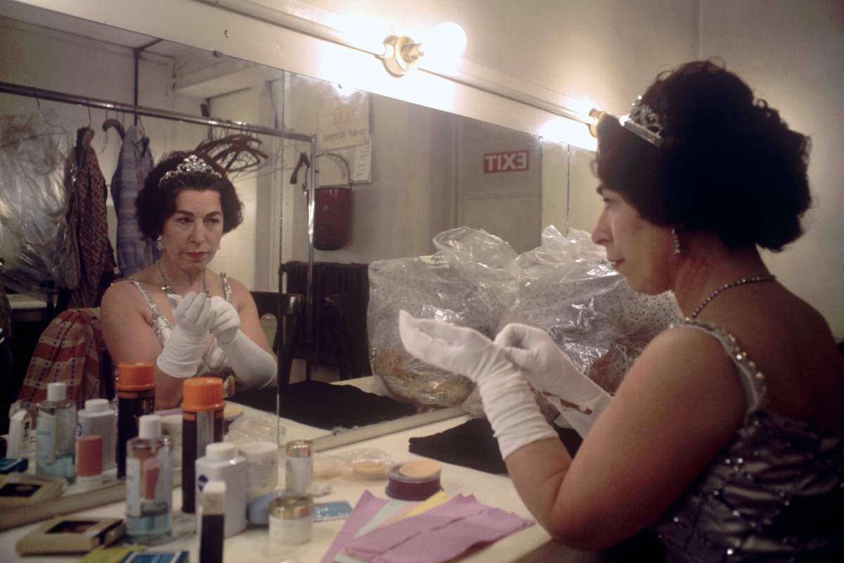 Jeanette Charles in a dressed room, costumed as the queen.