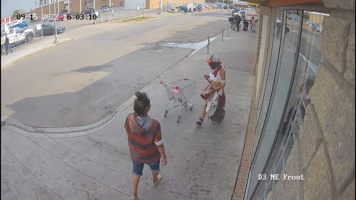 Screenshot from a video showing two women interacting on 100 Street near 106 Avenue in Chinatown before one is arrested by Edmonton police on Thursday, Sept. 15, 2022. One of the women was armed with a knife.