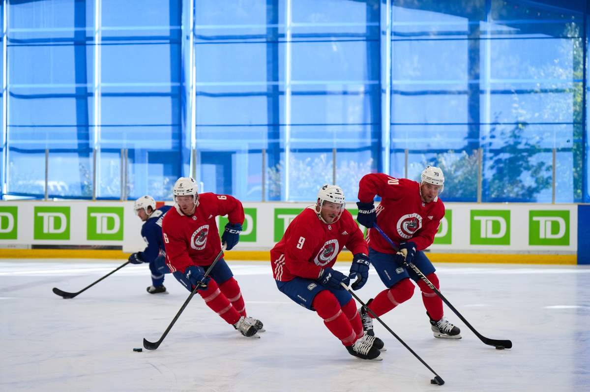 Vancouver Canucks forwards Brock Boeser, left, J.T. Miller, middle, and Tanner Pearson skate during training-camp action in Whistler, B.C., on Thursday, Sept. 22, 2022.