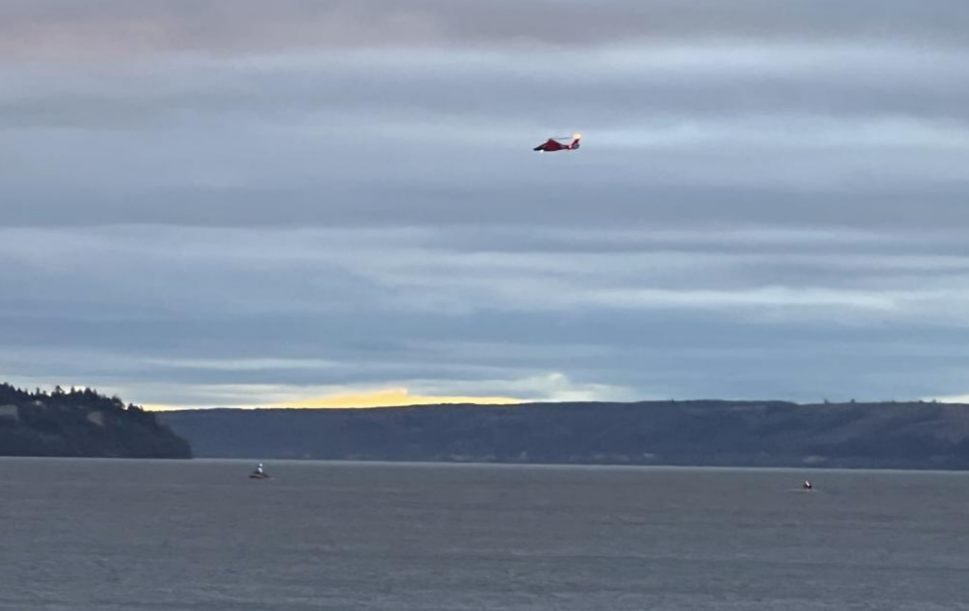A Coast Guard helicopter searches the area where a floatplane crashed near Whidbey Island, Wash., Sun. Sept. 4, 2022.