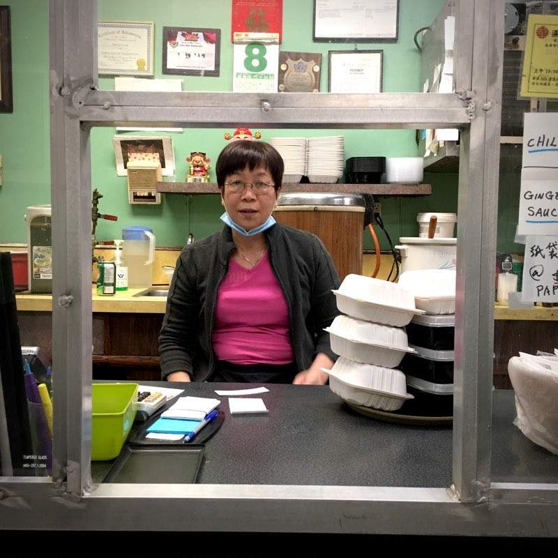 Tracy Li working the front counter of Gain Wah restaurant on the night before the September 9, 2022 fire.