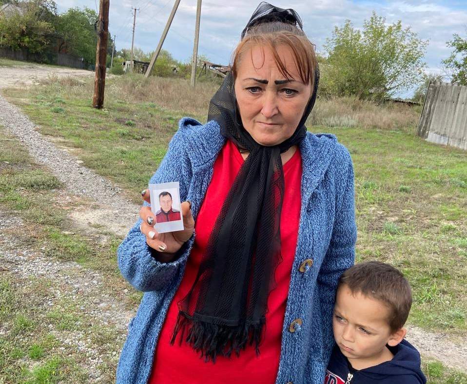 Viktoriia Nikolienko holds photo of her husband Arsen, killed by Russian forces in Dibrova, Ukraine.