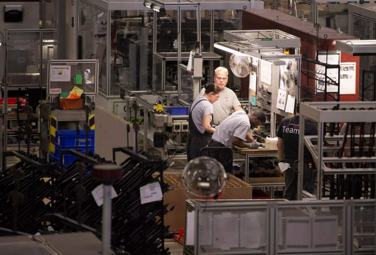 FILE - Workers at the Brose Canada plant in London, Ontario, on February 27, 2014.
