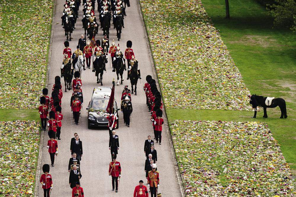 Emma, the monarch’s Fell pony, right, stands as the Ceremonial Procession of the coffin of Queen Elizabeth II arrives at Windsor Castle for the Committal Service at St George’s Chapel, in Windsor, England, Monday, Sept. 19, 2022.
