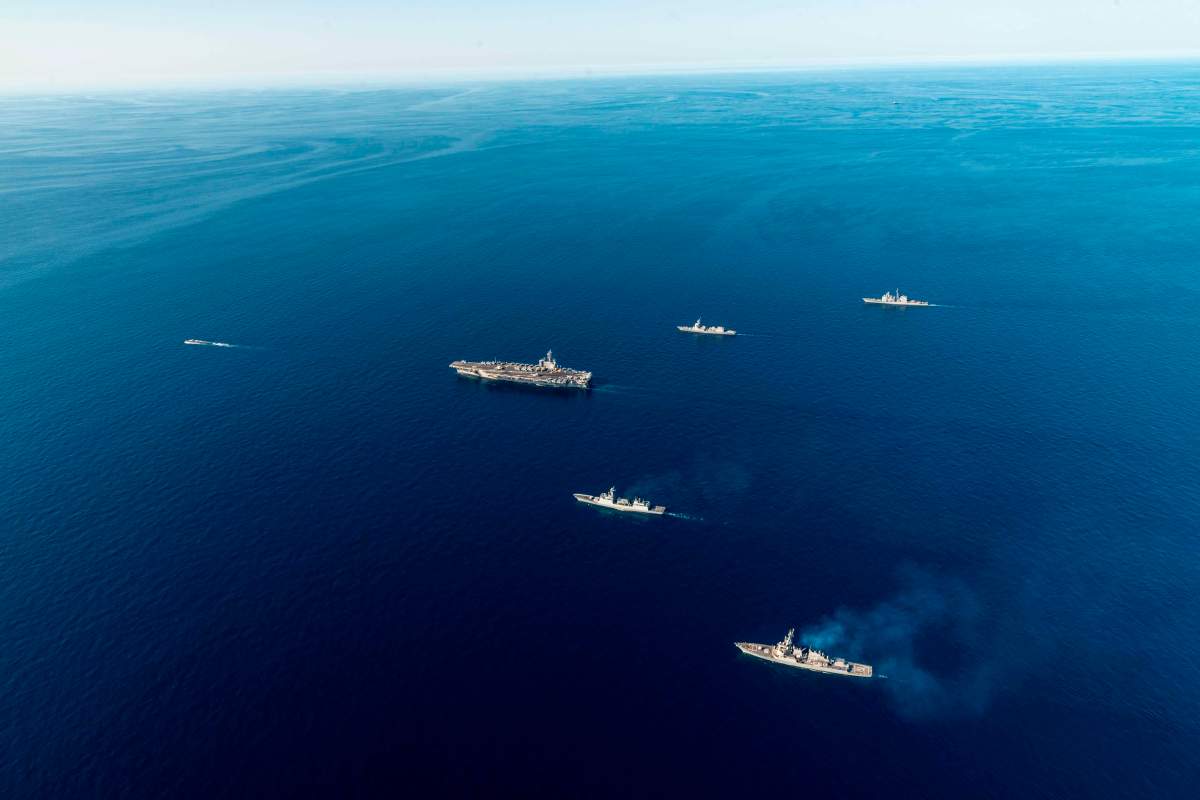 In this photo provided by the South Korea Defense Ministry, the USS Ronald Reagan aircraft carrier, second from left, participates in a joint anti-submarine drill among South Korea, the United States and Japan in waters off South Korea’s eastern coast in South Korea, Friday, Sept. 30, 2022. South Korea, U.S. and Japanese warships launched their first trilateral anti-submarine drills in five years on Friday, after North Korea renewed missile tests this week in an apparent response to bilateral training by South Korean and U.S. forces.