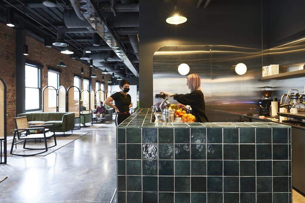 Workers are seen around a cafe-style bar in Lightspeed’s Montreal office in an undated handout photo. 