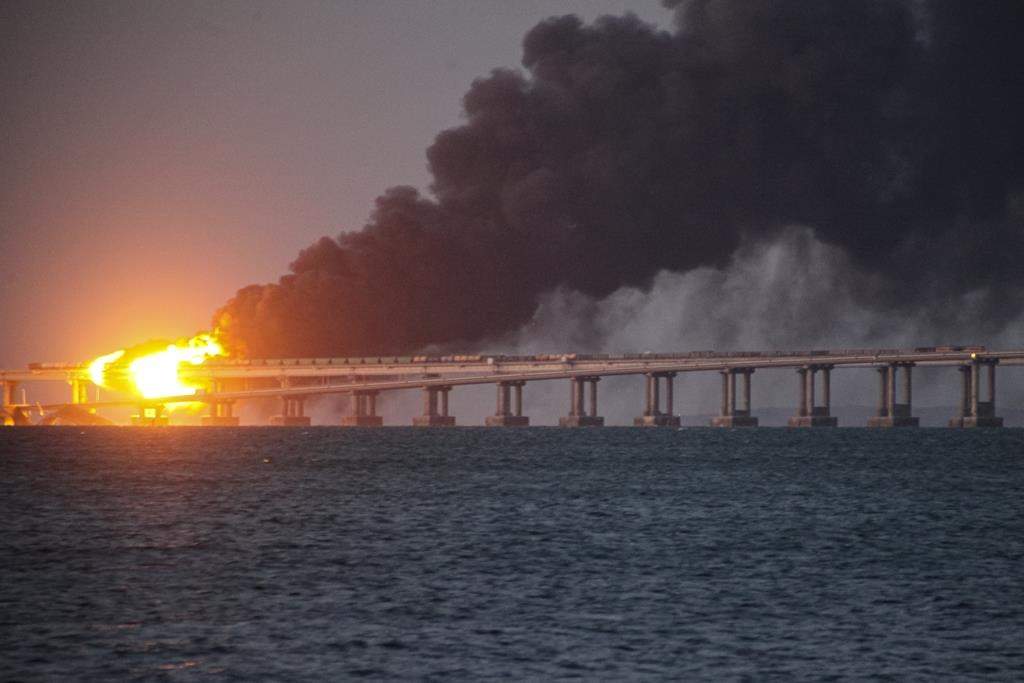 Flame and smoke rise from the Crimean Bridge connecting the Russian mainland and the Crimean peninsula over the Kerch Strait, in Kerch, Crimea, Saturday, Oct. 8, 2022. Russian authorities say a truck bomb has caused a fire and the partial collapse of a bridge linking Russia-annexed Crimea with Russia. Three people have been killed. The bridge is a key supply artery for Moscow’s faltering war effort in southern Ukraine. (AP Photo)