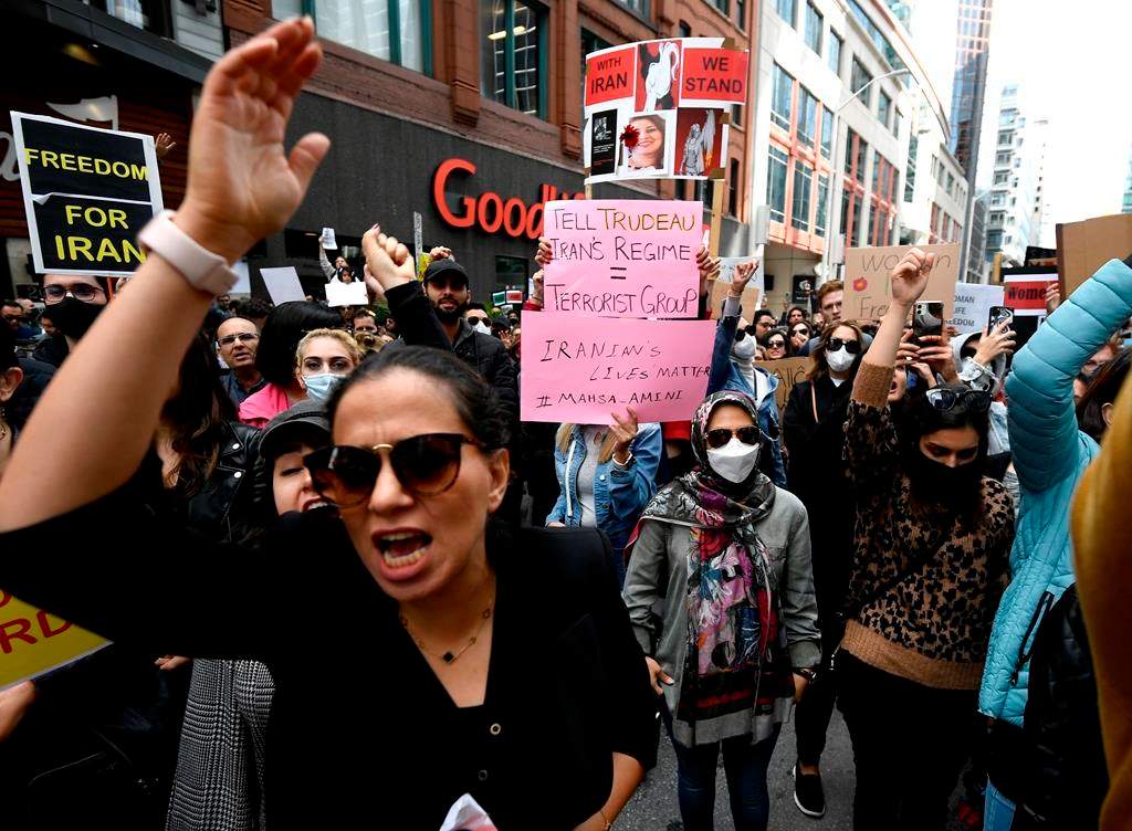 Members of the Iranian community and their supporters rally in solidarity with protesters in Iran, after 22-year-old Mahsa Amini died in police custody for allegedly improperly wearing a hijab, in Ottawa on Sunday, Sept. 25, 2022. THE CANADIAN PRESS/Justin Tang