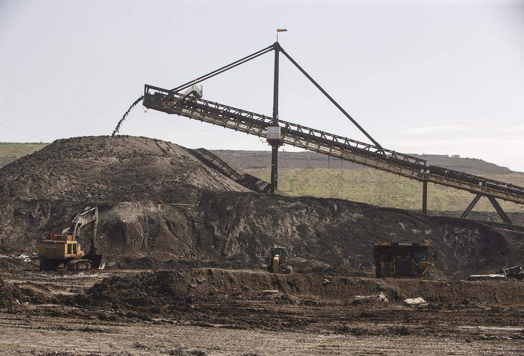 A file photo of a hopper moving dirt in Suncor's Millennium mine in the oilsands in Fort McMurray Alta, on Monday June 13, 2017.