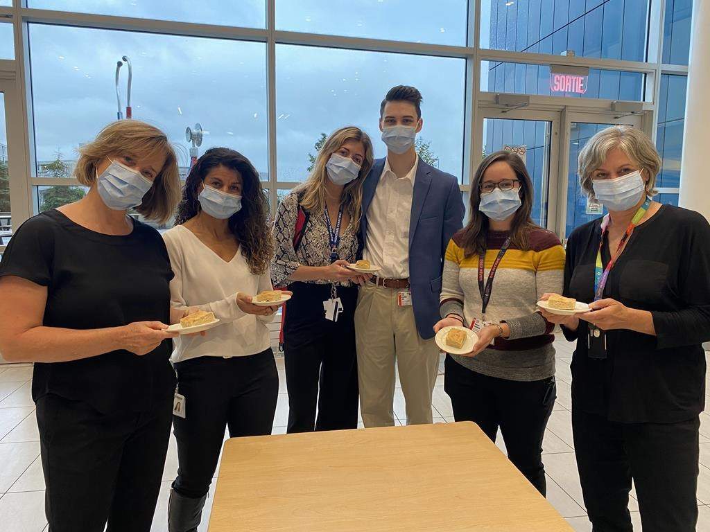 McGill University Health Centre staff members Julie Woodfine, left to right, Christiane Azzi, Megan Kouri, Brandon Hall, Maryse Fournier and Dr. Marie-Josee Brouillette pose for a photo with plates of bannock, an Indigenous type of fried bread, in a Sept. 2022, handout photo. THE CANADIAN PRESS/HO-MUHC