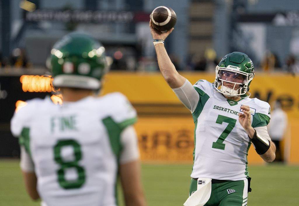 Saskatchewan Roughriders quarterbacks Cody Fajardo (7) and Mason Fine (8) warm up prior to football action against the Hamilton Tiger-Cats in Hamilton, Friday, Oct. 7, 2022.