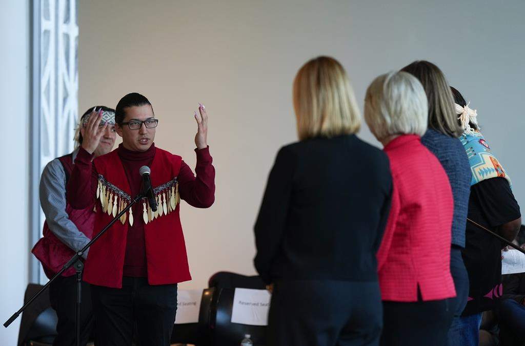 Squamish Nation councillor Khelsilem, left, addresses city councillors after presenting them with a copy of the United Nations Declaration on the Rights of Indigenous Peoples (UNDRIP) task force report, in Vancouver, on Wednesday, October 19, 2022. The final report is a result of a partnership with the Musqueam Indian Band, Squamish Nation and Tsleil-Waututh Nation. According to the task force it is the first co-developed strategy between Indigenous nations and a municipal government in Canada. 