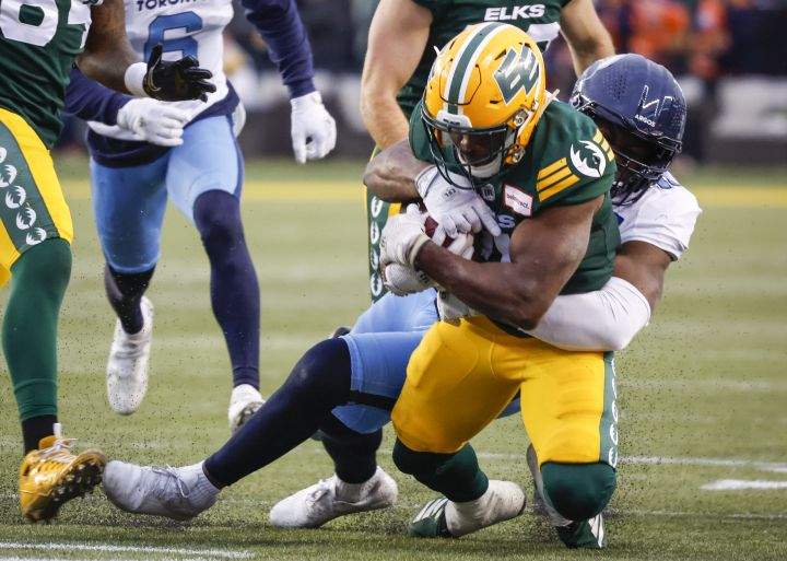Toronto Argonauts’ Henoc Muamba, right, brings down Edmonton Elks’ Kevin Brown during first half CFL football action in Edmonton, Saturday, Oct. 15, 2022.