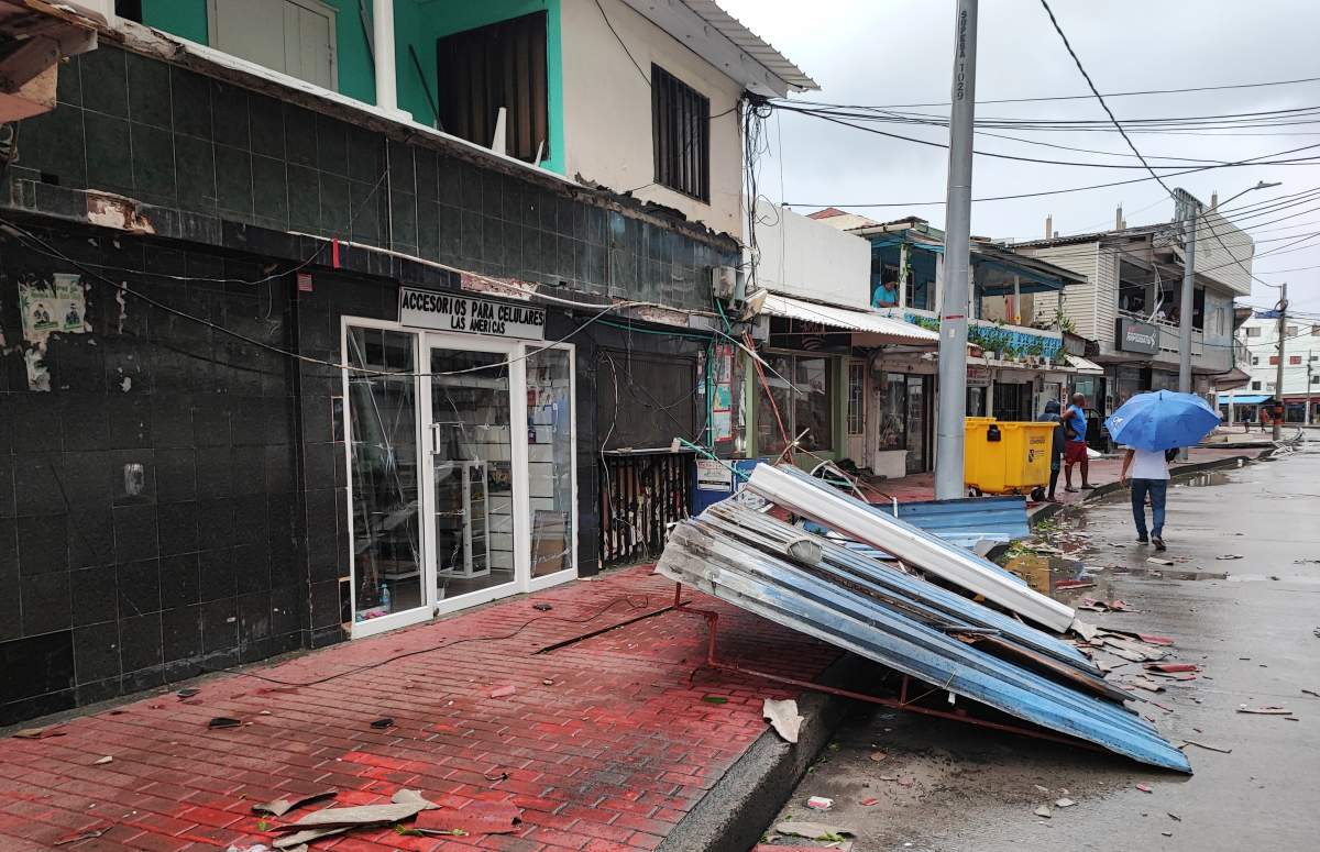 People walk past a damaged house in the aftermath of Hurricane Julia in San Andres island, Colombia, Sunday, Oct.9, 2022. Hurricane Julia hit Nicaraguaâ€™s central Caribbean coast on Sunday after lashing Colombiaâ€™s San Andres island, and a weakened storm was expected to emerge over the Pacific. (AP Photo/Daniel Parra).