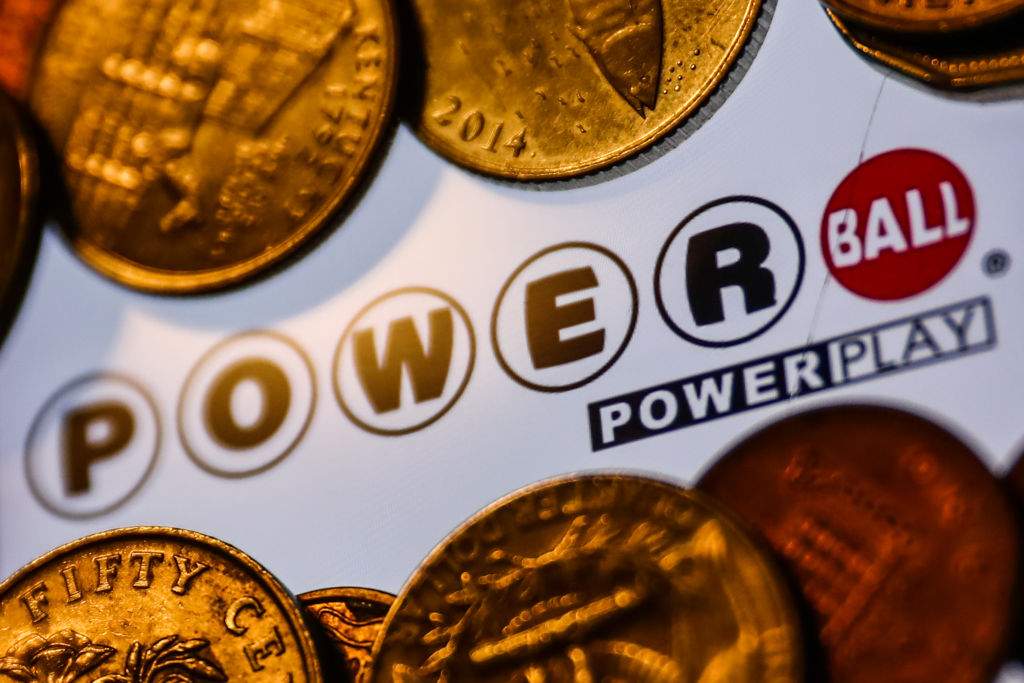 Powerball logo displayed on a phone screen and coins are seen in this illustration photo taken in Krakow, Poland on June 14, 2022.
