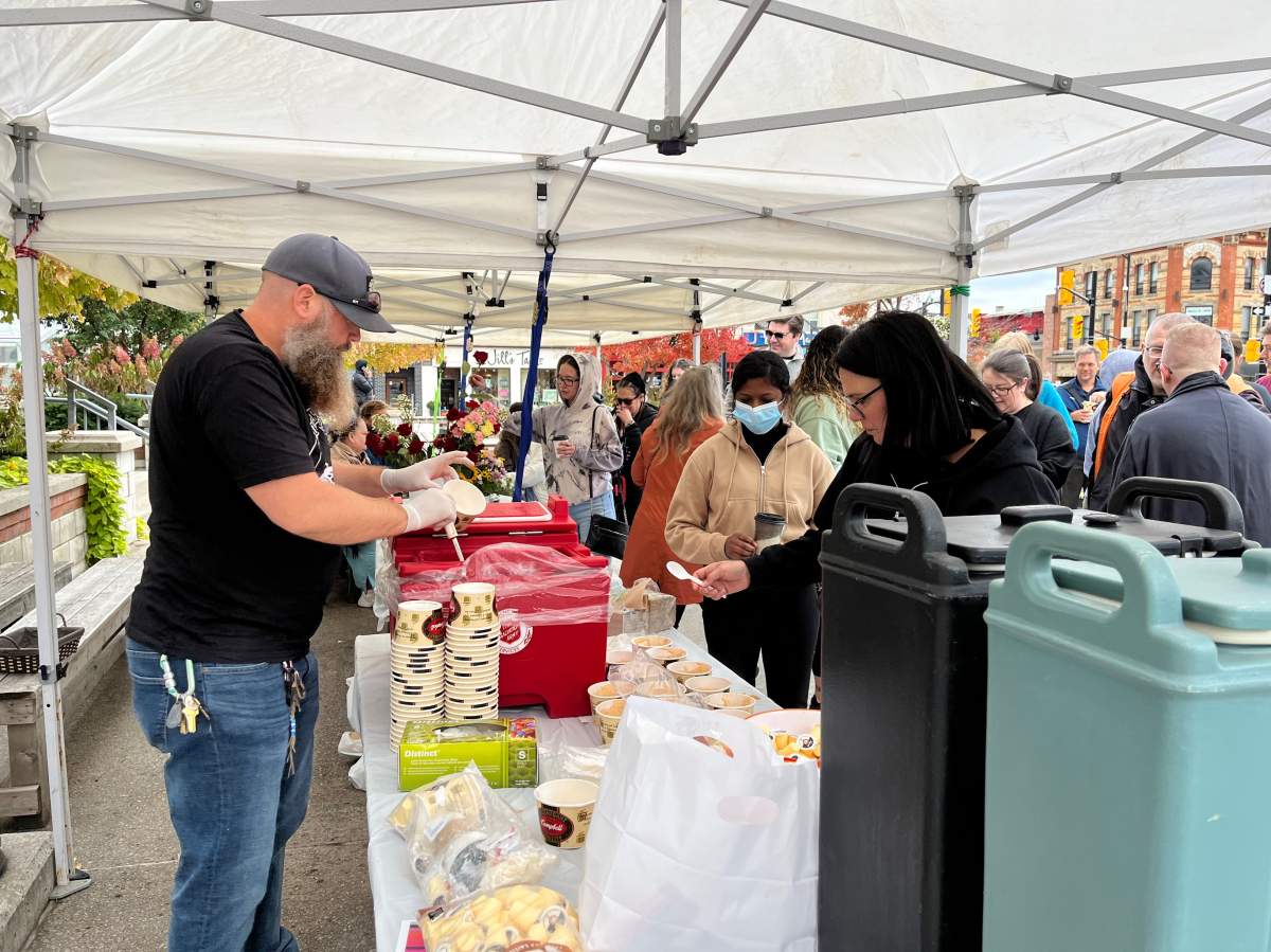 Volunteer Kyle Kerr doles out soup and bread during the ninth annual London Homeless Coalition Memorial Event at Covent Garden Market.