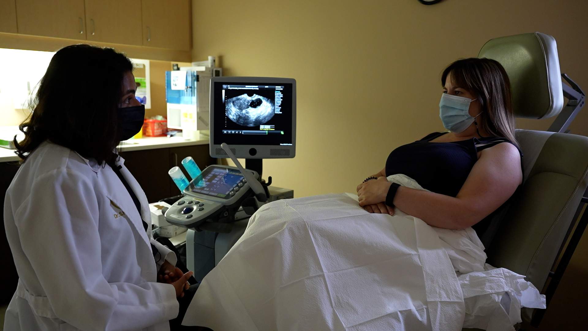 A doctor consults with her patient
