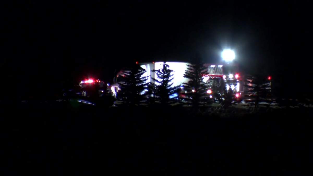 Emergency crews at the scene of a fatal collision near where Highway 22x turns into Highway 901 at the intersection of Highway 24 east of Calgary, on Friday, Oct. 21, 2022.