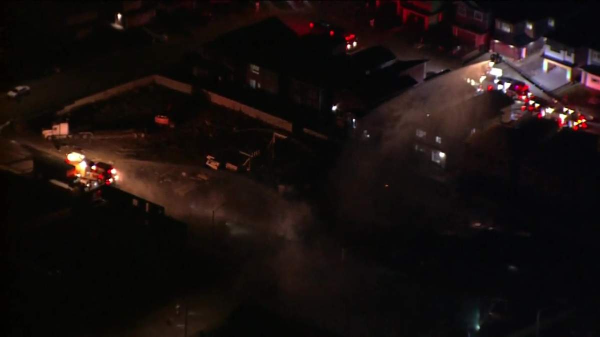 Edmonton Fire Rescue Services battle a fire at a house under construction in the city's southeast on Oct. 11, 2022.
