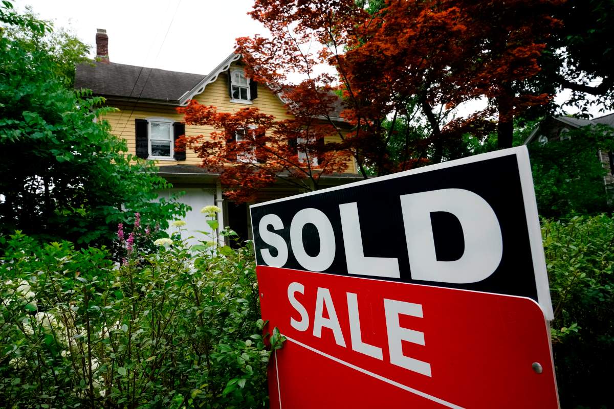 FILE - A sale sign stands outside a home in Wyndmoor, Pa., Wednesday, June 22, 2022.