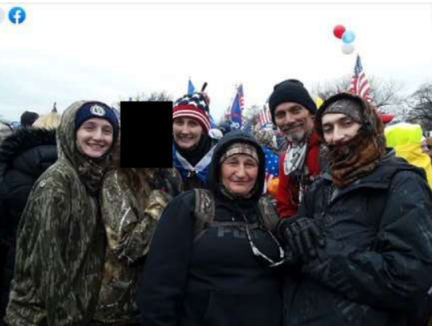 A photo of the Munn family outside the U.S. Capitol. The face of one child, who is a minor, is obscured.