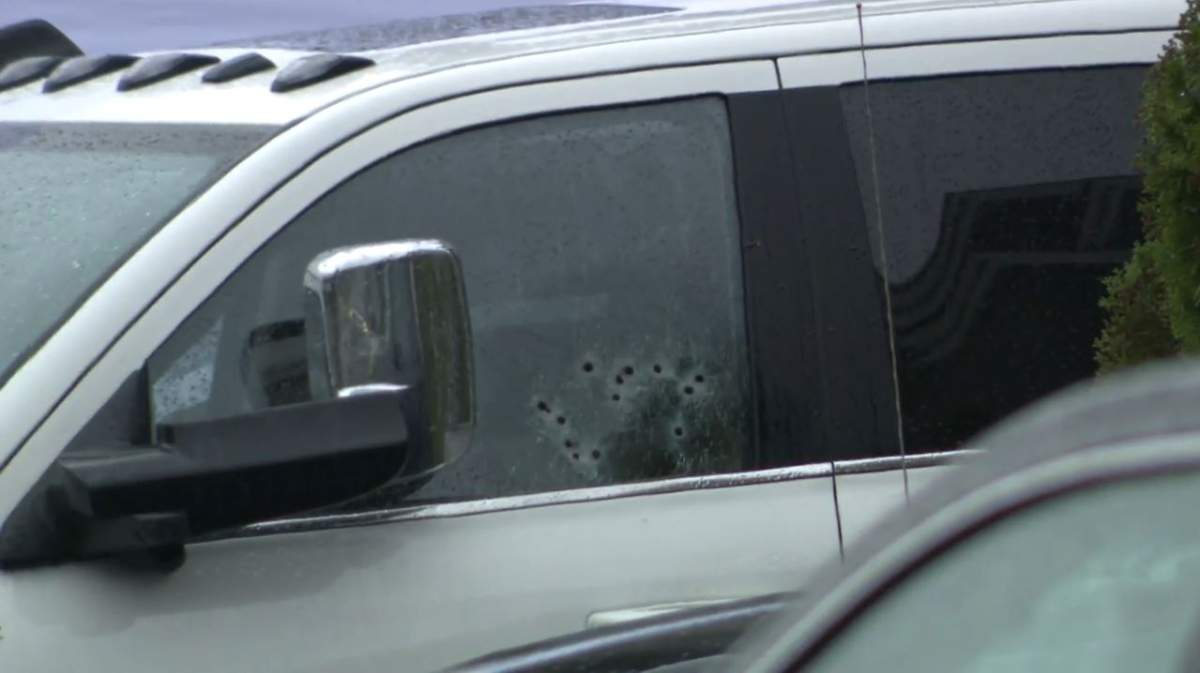 A vehicle at the crime scene was seen with apparent bullet holes in the driver’s side window.