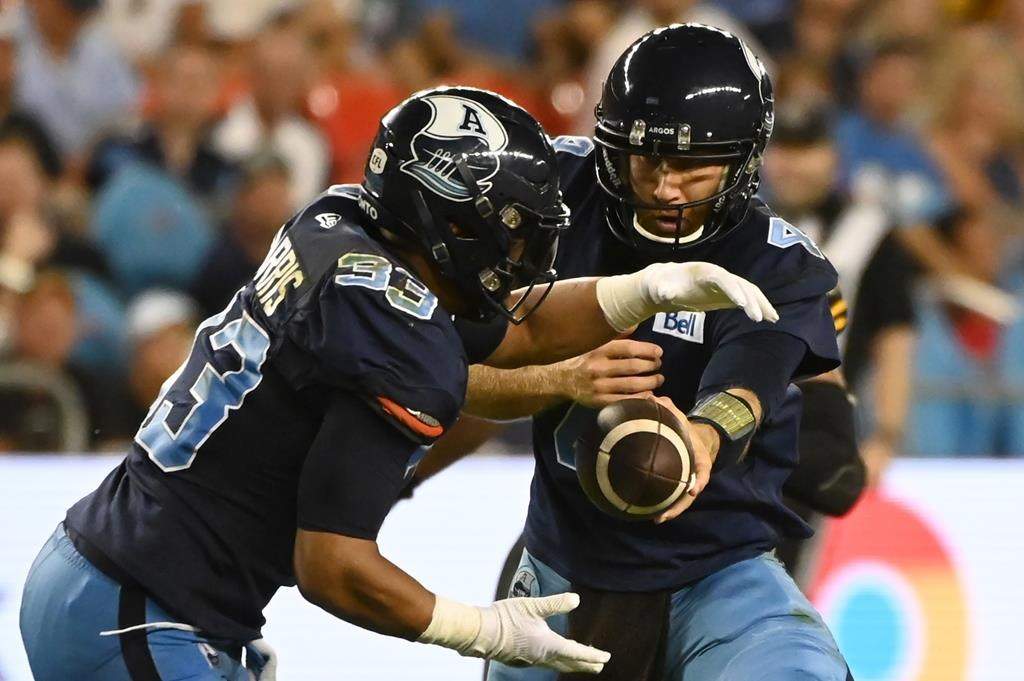 Toronto Argonauts quarterback McLeod Bethel-Thompson hands off the ball to running back Andrew Harris.