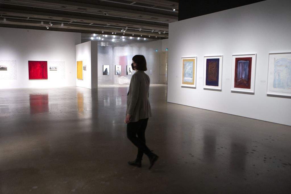 A woman walks through a display at the Art Gallery of Ontario, in Toronto on Thursday, December 2, 2021. THE CANADIAN PRESS/Chris Young.