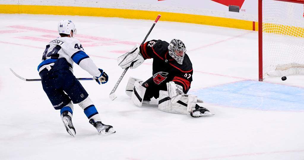 Winnipeg Jets’ Josh Morrissey (44) scores the game-winning goal against Carolina Hurricanes’ goaltender Pyotr Kochetkov (52) during overtime in NHL action in Winnipeg on Nov. 21. THE CANADIAN PRESS/Fred Greenslade