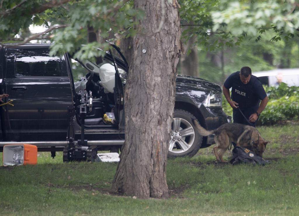 RCMP officer searches pickup truck that crashed through gates of Rideau Hall, July 2, 2020. THE CANADIAN PRESS/Adrian Wyld.