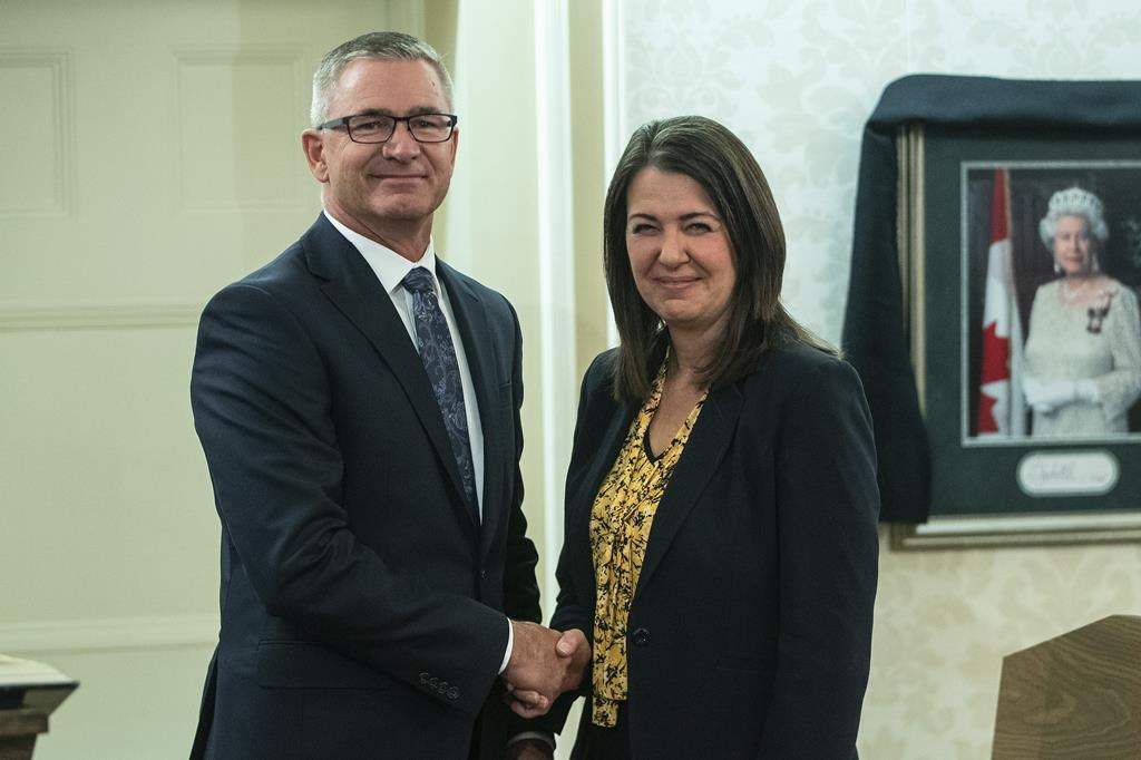 Toews shakes hands with Alberta Premier Danielle Smith after he was sworn into cabinet as President of Treasury Board and Minister of Finance in Edmonton, on Oct. 24, 2022. THE CANADIAN PRESS/Jason Franson.