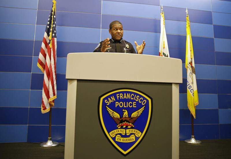 Police Chief Bill Scott stands behind a podium in uniform.