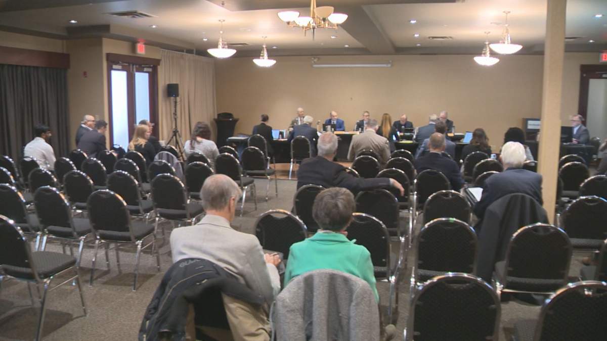 Members of the public can be seen at the public hearing in Regina on Nov. 23, 2022.