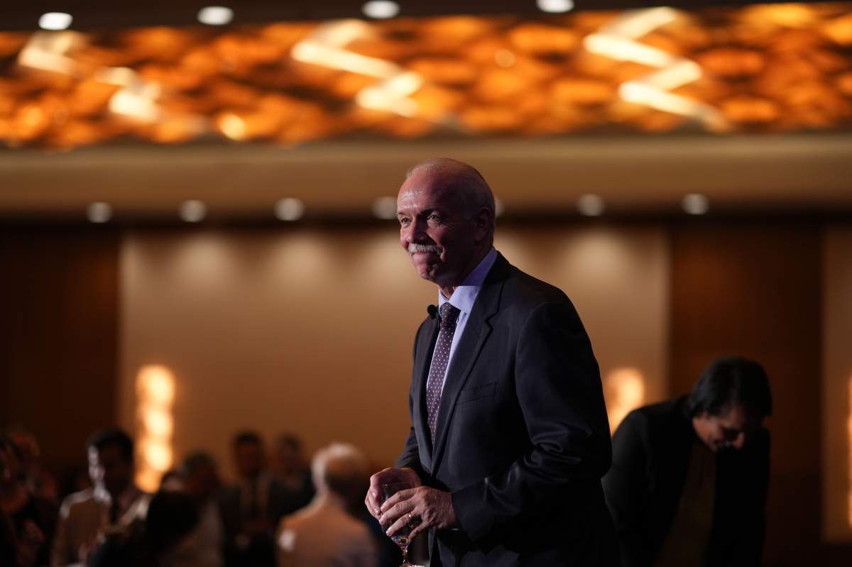 Outgoing B.C. Premier John Horgan leaves the stage after a question and answer session at a B.C. Chamber of Commerce luncheon on his last full day as premier of the province, in Vancouver, on Thursday, November 17, 2022. 
