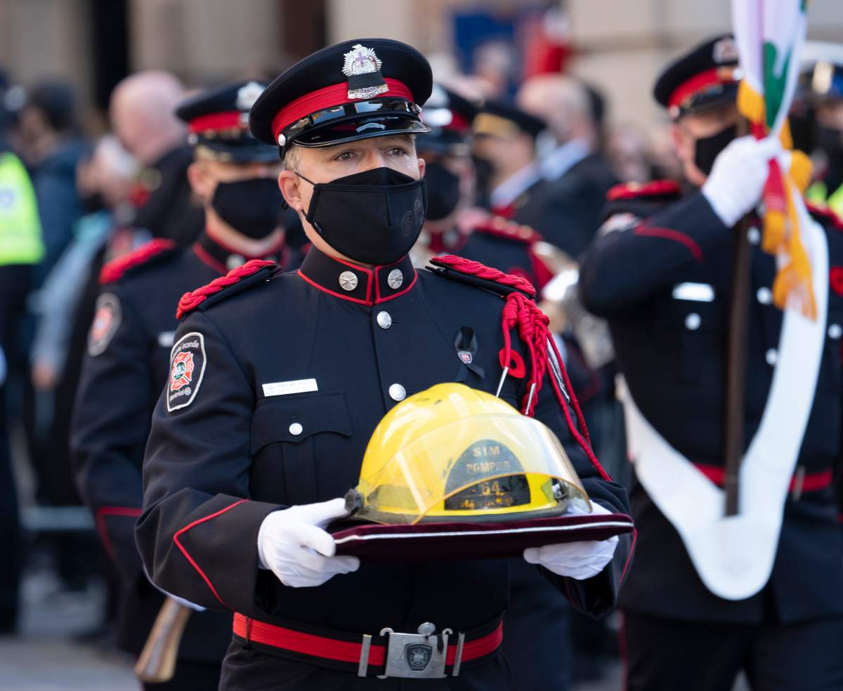 The helmet of fireman Pierre Lacroix is carried to the church for his funeral services in Montreal, Friday, Oct. 29, 2021. Lacroix drowned during a rescue operation in the Lachine Rapids.