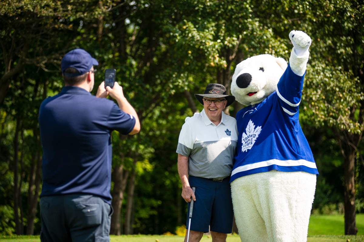 Former Toronto Maple Leafs player Ron Ellis poses for a photo with Carlton the Bear, the Maple Leafs mascot, during the Leafs & Legends Charity Golf Classic at the RattleSnake Point Golf Club, in Milton, Ont., Wednesday, September 11, 2019.