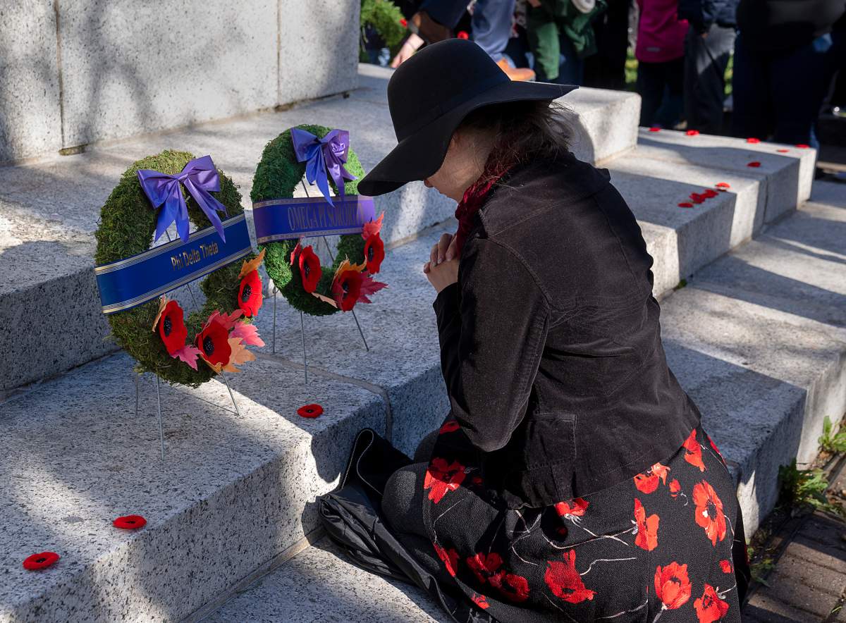 A woman pays her respects at Remembrance Day ceremonies at the Grand Parade in Halifax on Friday, Nov. 11, 2022.