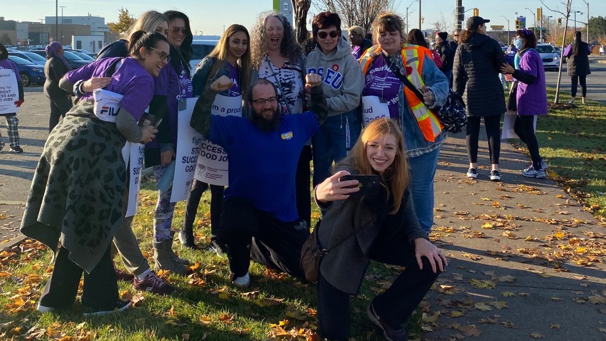 HWDSB chair Dawn Danko taking picture with group of education workers picketing at Lime Ridge Mall on Nov. 4, 2022.